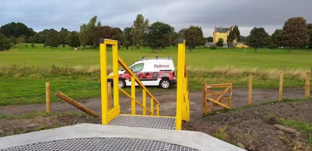 FRP pedestrian bridge with yellow handrails for outdoor access