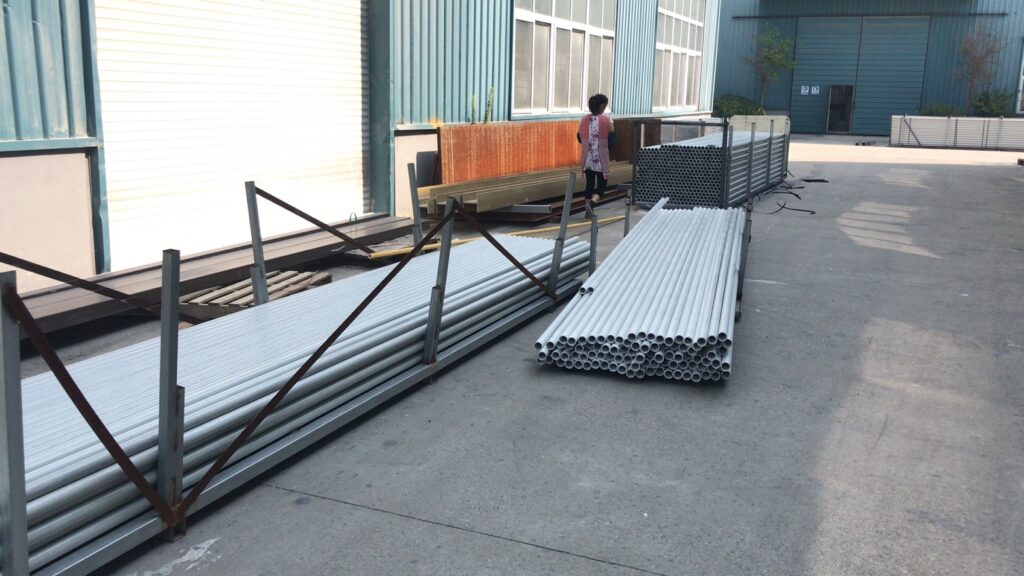 Machs FRP round tubes stacked outside factory workshop for shipment
