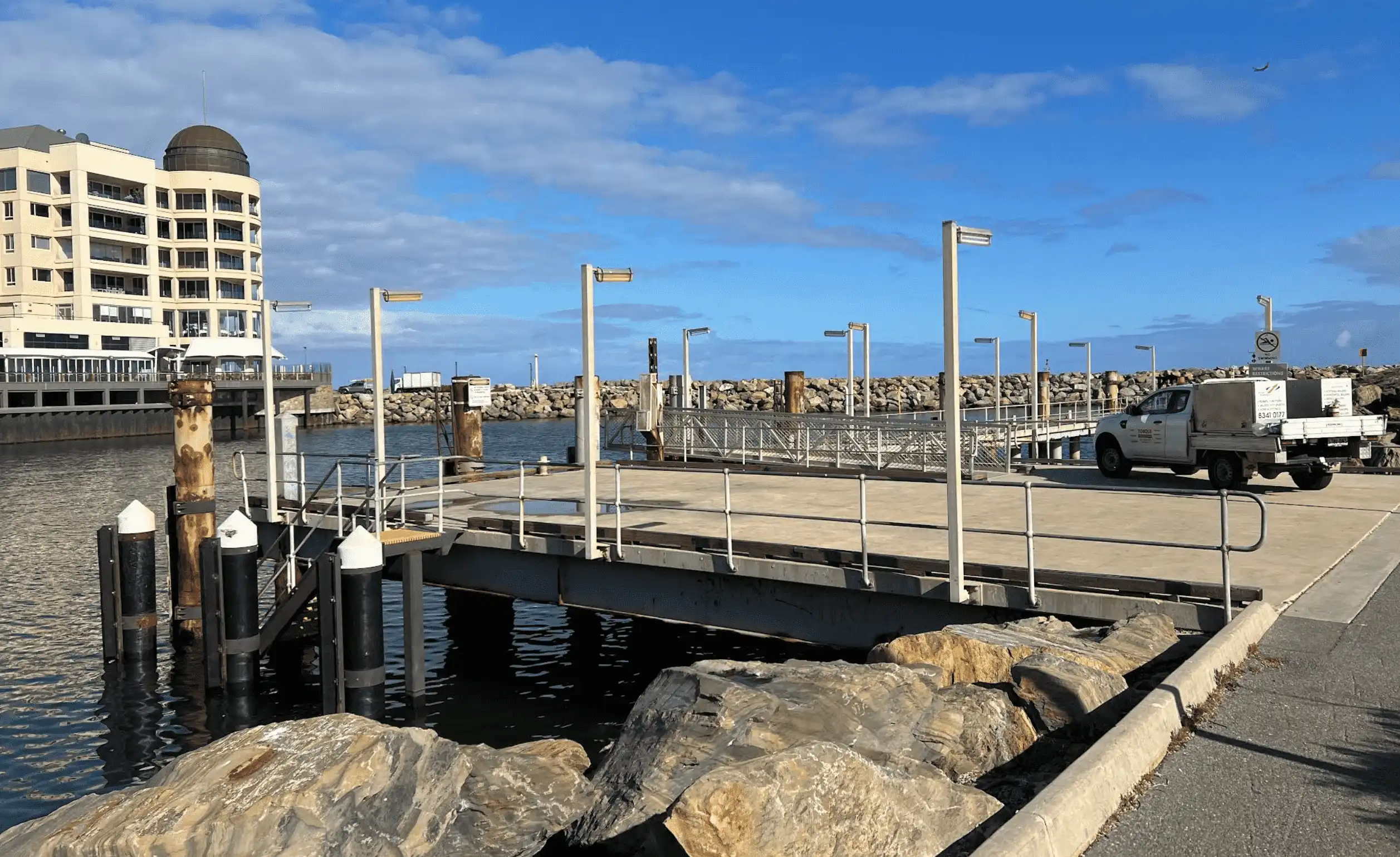 View of Glenelg Wharf in Adelaide with FRP stair access to the water and nearby marina buildings