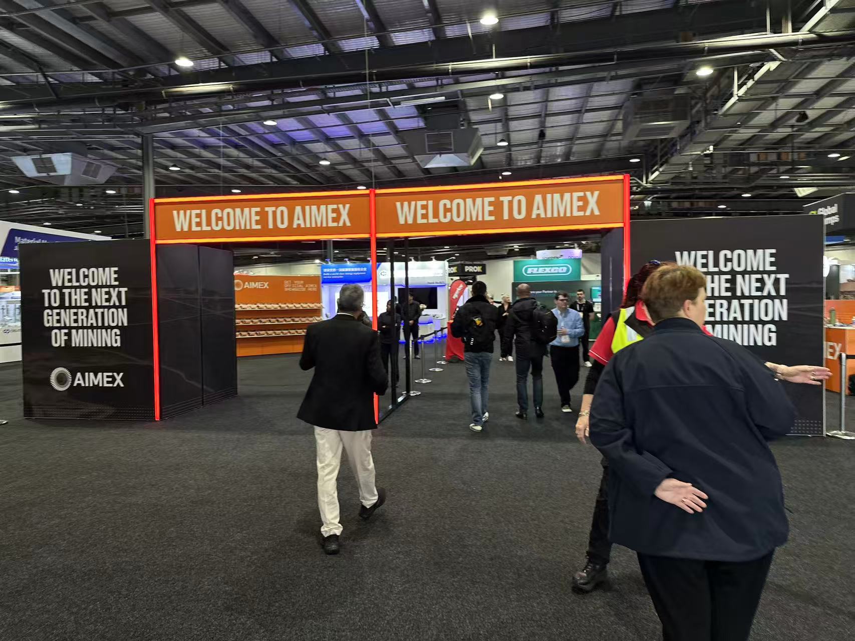 Entrance to AIMEX 2024 exhibition with banners reading 'Welcome to AIMEX' and 'Welcome to the Next Generation of Mining'.