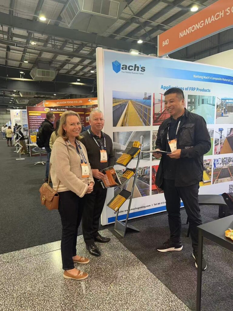 Visitors discussing FRP product applications with Machs representatives at AIMEX 2024 exhibition booth.
