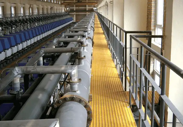 Yellow FRP grating walkway installed in an industrial plant for safe access and corrosion resistance
