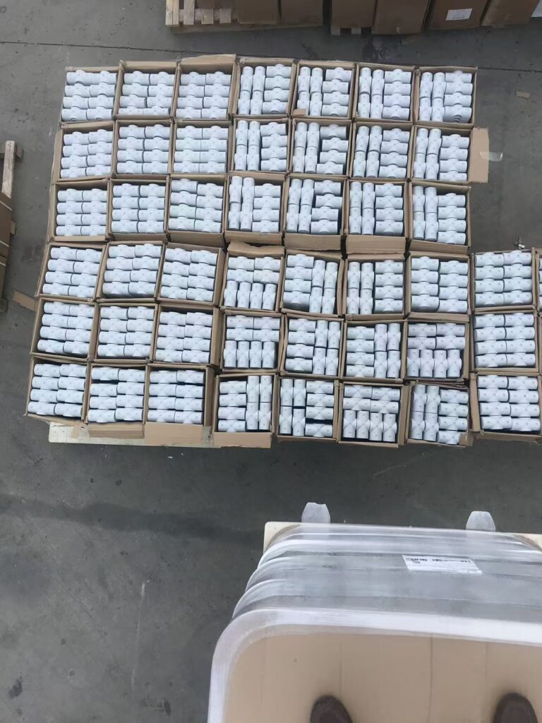 Stacked cartons filled with FRP handrail fittings, arranged for bulk packaging and delivery.