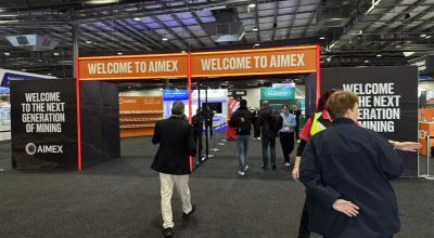 Entrance to AIMEX 2024 exhibition with banners reading 'Welcome to AIMEX' and 'Welcome to the Next Generation of Mining'.
